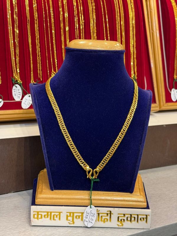 Wide linked chain with a simple clasp on a blue velvet stand